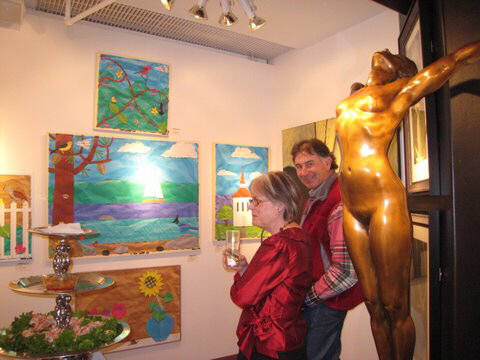Artist: Gallery Event Photos, Title: Kathleen Hooks viewing some of Bill Braun's artwork...talk about two opposite painting styles - click for larger image