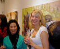 Gallery Event Photos - Gallery Asst. Carrie, tells Masami Olsen that she has a horse just like the one behind them.